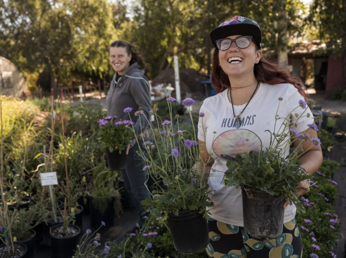 Two employees working at TMHA’s Growing Grounds Garden and Nursery. 
Photo courtesy of Transitions Mental Health Association
